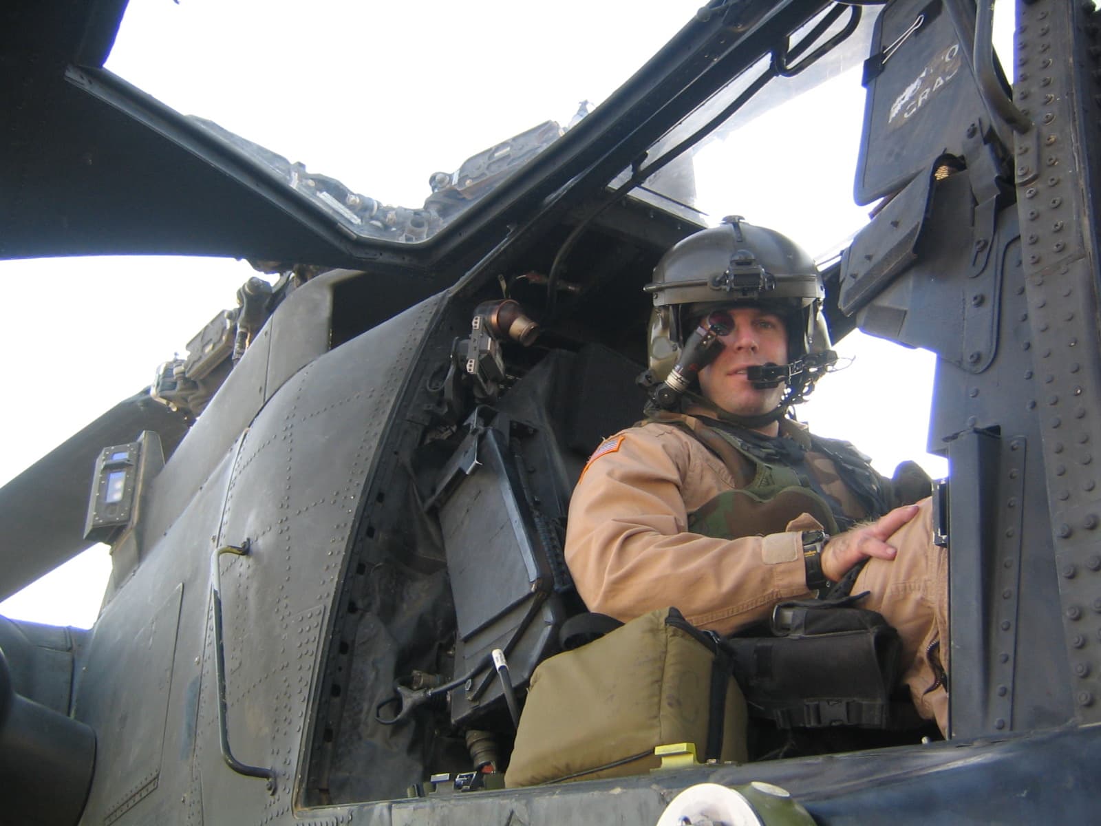 Mark Zais in flight gear in an AH-64D Apache cockpit